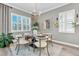 Bright dining area with large windows, stylish decor, and seating for four at 3477 Barbour Trl, Odessa, FL 33556