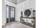Elegant entryway with a decorative door, stylish console table, and modern artwork at 3477 Barbour Trl, Odessa, FL 33556