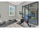 Brightly lit exercise room with sliding glass door and an elliptical and rowing machines at 3477 Barbour Trl, Odessa, FL 33556