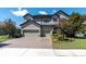 Charming two-story home with a three car garage, manicured landscaping, and appealing architectural details at 3477 Barbour Trl, Odessa, FL 33556