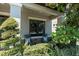 Inviting front porch with cozy seating area surrounded by lush plants at 3477 Barbour Trl, Odessa, FL 33556