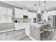 Modern kitchen featuring a large island with seating, stainless steel appliances, and ample counter space at 3477 Barbour Trl, Odessa, FL 33556