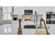 Modern kitchen featuring white cabinets, stainless steel appliances, and a stylish backsplash at 3477 Barbour Trl, Odessa, FL 33556