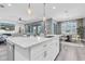 Open-concept kitchen island with seating, perfect for casual dining and entertaining with open access to the living room at 3477 Barbour Trl, Odessa, FL 33556
