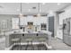 Contemporary kitchen showcasing a large island with seating, white cabinetry, and stainless steel appliances at 3477 Barbour Trl, Odessa, FL 33556