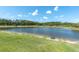 Breathtaking lake view from the property, featuring lush greenery and a peaceful setting at 3477 Barbour Trl, Odessa, FL 33556