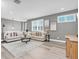 Comfortable living room with a large sectional sofa, modern decor, and lots of natural light at 3477 Barbour Trl, Odessa, FL 33556