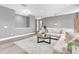 Cozy living room featuring an oversized sectional, gray walls, and a decorative gray rug at 3477 Barbour Trl, Odessa, FL 33556