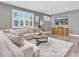 Spacious living room boasts a large sectional couch, media center, and gray walls at 3477 Barbour Trl, Odessa, FL 33556
