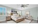 Inviting main bedroom features a ceiling fan, soft green walls, and plantation shutters at 3477 Barbour Trl, Odessa, FL 33556