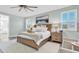 Spacious main bedroom with ceiling fan, natural light, and comfortable seating area at 3477 Barbour Trl, Odessa, FL 33556
