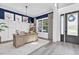 Home office featuring navy accent wall, wainscoting, and ample natural light at 3477 Barbour Trl, Odessa, FL 33556