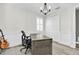Office space with custom desk, modern chandelier, wainscoting, and a closet at 3477 Barbour Trl, Odessa, FL 33556