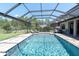 Relaxing screened-in pool and patio area with chairs, ideal for entertaining or enjoying the lush surroundings at 3477 Barbour Trl, Odessa, FL 33556