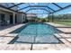 Sparkling screened-in pool with a waterfall feature and a spacious deck area at 3477 Barbour Trl, Odessa, FL 33556