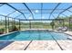 Beautiful in-ground pool enclosed with a screened-in lanai overlooking a peaceful backyard and lake at 3477 Barbour Trl, Odessa, FL 33556