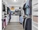 Organized walk-in closet with custom shelving, drawers, and ample hanging space for clothes and accessories at 3477 Barbour Trl, Odessa, FL 33556
