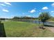 Scenic water view from the backyard, enhanced by a wrought iron fence, providing both beauty and security at 3477 Barbour Trl, Odessa, FL 33556