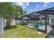 A backyard boasts a fully screened-in pool area, shed, and mature trees at 3545 59Th N Ln, St Petersburg, FL 33710