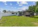 A spacious backyard with a well-maintained lawn and screened-in pool area provides an ideal space for relaxation and recreation at 3545 59Th N Ln, St Petersburg, FL 33710
