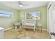 Cozy Bedroom with green walls, travertine flooring, and natural light from multiple windows at 3545 59Th N Ln, St Petersburg, FL 33710