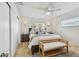 Bright main bedroom with a bench at the foot of the bed and side tables at 3545 59Th N Ln, St Petersburg, FL 33710