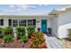 Close-up of the home's entrance, highlighting a vibrant blue door framed by lush, manicured landscaping at 3545 59Th N Ln, St Petersburg, FL 33710