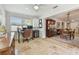 Bright home office space featuring travertine tile, work area, and seamless transition to the dining room at 3545 59Th N Ln, St Petersburg, FL 33710