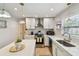 Bright kitchen with white cabinetry, subway tile backsplash, and a stainless steel range hood at 3545 59Th N Ln, St Petersburg, FL 33710