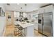 Modern kitchen featuring white cabinets, stainless steel appliances, and a center island with seating at 3545 59Th N Ln, St Petersburg, FL 33710