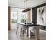 The dining room features a decorative accent wall, pendant lighting, and a modern table with seating for six at 36871 Sagemoor Dr, Zephyrhills, FL 33541