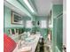 Retro bathroom featuring a vessel sink, stone floors, and green tile at 3898 49Th S Ave, St Petersburg, FL 33711