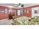 Charming bedroom with leaf-patterned bedding, a woven ceiling fan, and wood dresser at 3898 49Th S Ave, St Petersburg, FL 33711
