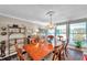 Well-lit dining room with a chandelier, ample windows, and classic furniture at 3898 49Th S Ave, St Petersburg, FL 33711