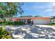 Charming single-story home with a spacious driveway, lush landscaping, and a welcoming front entrance at 3898 49Th S Ave, St Petersburg, FL 33711
