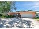 Beautiful home with lush landscaping, mature palm trees, and a large driveway at 3898 49Th S Ave, St Petersburg, FL 33711