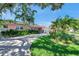 Well-manicured home featuring vibrant landscaping, mature trees, and a spacious driveway at 3898 49Th S Ave, St Petersburg, FL 33711