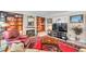 Living room with a fireplace, built-in shelving, comfortable seating, and large windows at 3898 49Th S Ave, St Petersburg, FL 33711