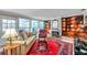 Cozy living room with a fireplace, built-in shelving, large windows, and comfortable seating at 3898 49Th S Ave, St Petersburg, FL 33711