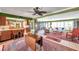 Open living area with seamless flow to kitchen, features ceiling fan, neutral walls, and light-filled windows at 3898 49Th S Ave, St Petersburg, FL 33711