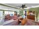 Open living room featuring tiled floors, a fireplace, a ceiling fan, and a charming mix of furniture at 3898 49Th S Ave, St Petersburg, FL 33711