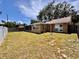 Expansive backyard with well-maintained lawn, privacy fence, and screened in patio, ideal for outdoor enjoyment at 3902 Glissade Dr, New Port Richey, FL 34652