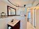 This bathroom features tile floor and walls, and matching wood vanity and mirror at 3902 Glissade Dr, New Port Richey, FL 34652