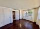 This bedroom features hardwood flooring, a large window, and a closet at 3902 Glissade Dr, New Port Richey, FL 34652