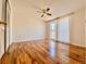 This bedroom features hardwood flooring, a ceiling fan, and a large window at 3902 Glissade Dr, New Port Richey, FL 34652
