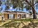 Attractive home with a well-kept lawn, a welcoming porch, and an attached garage at 3902 Glissade Dr, New Port Richey, FL 34652