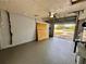 Spacious garage with painted floor and walls, offering ample storage or parking, and an open view at 3902 Glissade Dr, New Port Richey, FL 34652