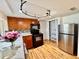 Well-equipped kitchen featuring wood cabinets, black appliances, and a sleek design at 3902 Glissade Dr, New Port Richey, FL 34652