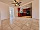Bright kitchen with wood cabinets, black appliances, and stylish track lighting at 3902 Glissade Dr, New Port Richey, FL 34652