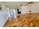Spacious living room featuring wood flooring and a contemporary ceiling fan at 3902 Glissade Dr, New Port Richey, FL 34652